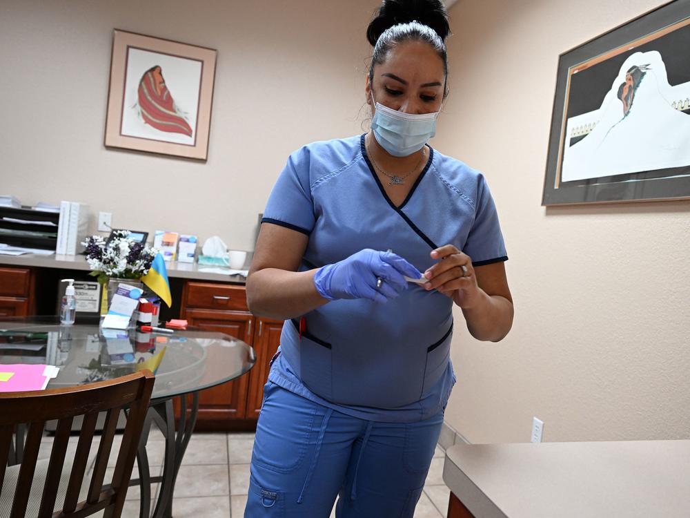 A medical assistant checks a patient's pregnancy test at the Women's Reproductive Clinic, which provides legal medication abortion services, in Santa Teresa, N.M., in a photo taken last month.