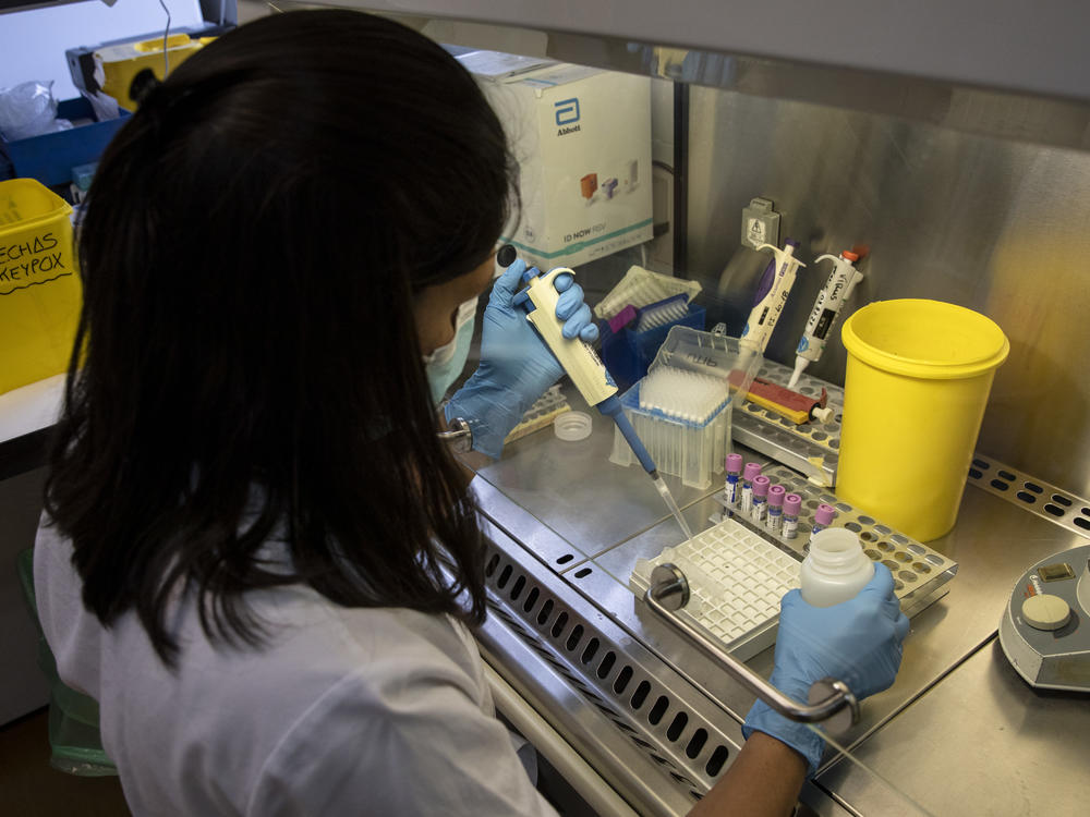 Europe is at the center of the monkeypox outbreak — and it must act quickly to prevent the virus from becoming established, the WHO says. Here, a medical laboratory technician works with suspected monkeypox samples to be tested at La Paz hospital in Madrid, Spain, last month.