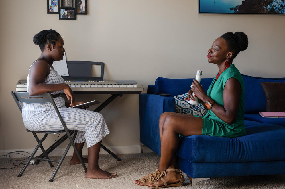 Terri Logan (right) practices music with her daughter, Amari Johnson (left), at their home in Spartanburg, S.C. When Logan's daughter was born premature, the medical bills started pouring in and stayed with her for years. Then, a few months ago, she discovered a nonprofit had paid off her debt.