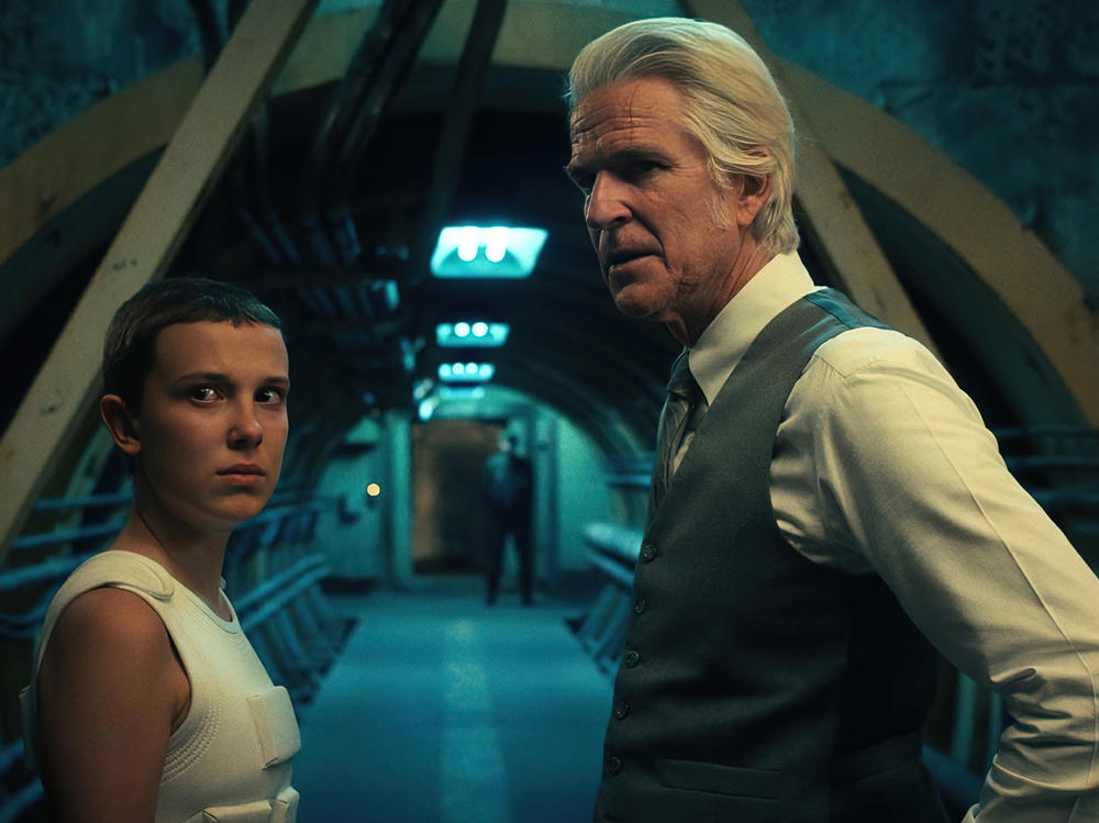Millie Bobby Brown as Eleven and Matthew Modine as Dr. Martin Brenner in <em>Stranger Things</em>.