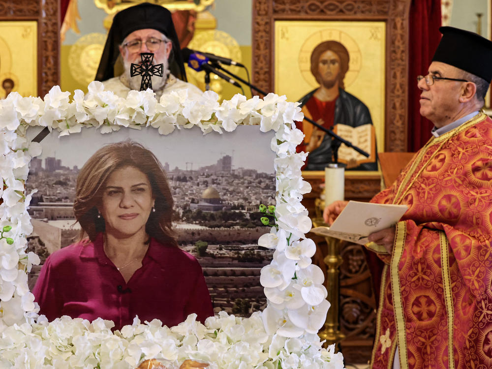 Archimandrite Abdullah Yulio, parish priest of the Melkite Greek Catholic church in Ramallah, speaks during a memorial service in June for the late Palestinian and veteran Al Jazeera journalist Shireen Abu Akleh. The Palestinian Authority says it has shared the bullet that killed Abu Akleh with U.S. officials.