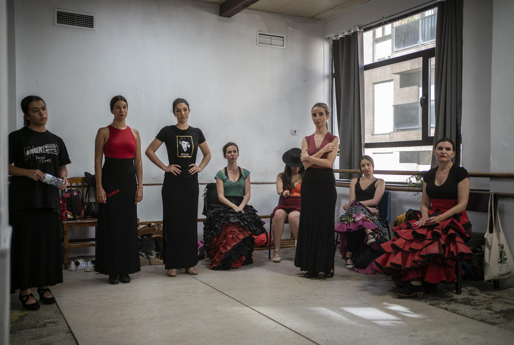 Students listen to Carmen attentively as she gives final instructions for their upcoming showcase.