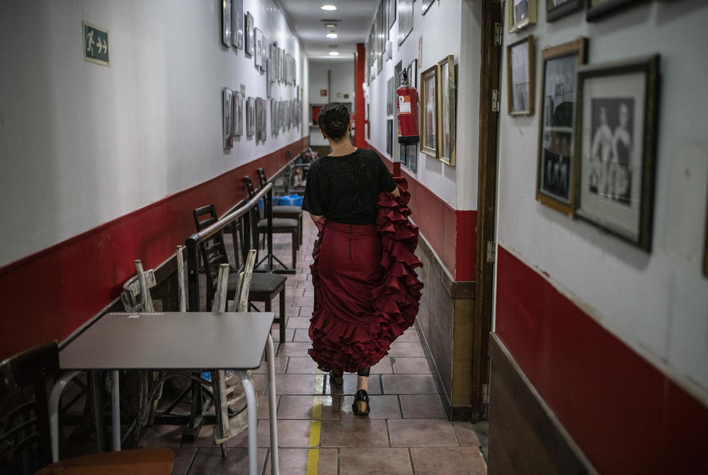 A student walks down the hallways at Amor de Dios, full of history.