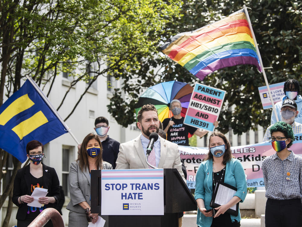 Alabama Rep. Neil Rafferty speaks in support of transgender rights during a rally outside the Alabama State House in 2021. The state is using the<em> Dobbs</em> ruling, which overturned <em>Roe v. Wade</em> and ended abortion access as a federal right, to argue it has the authority to ban gender-affirming medical care.