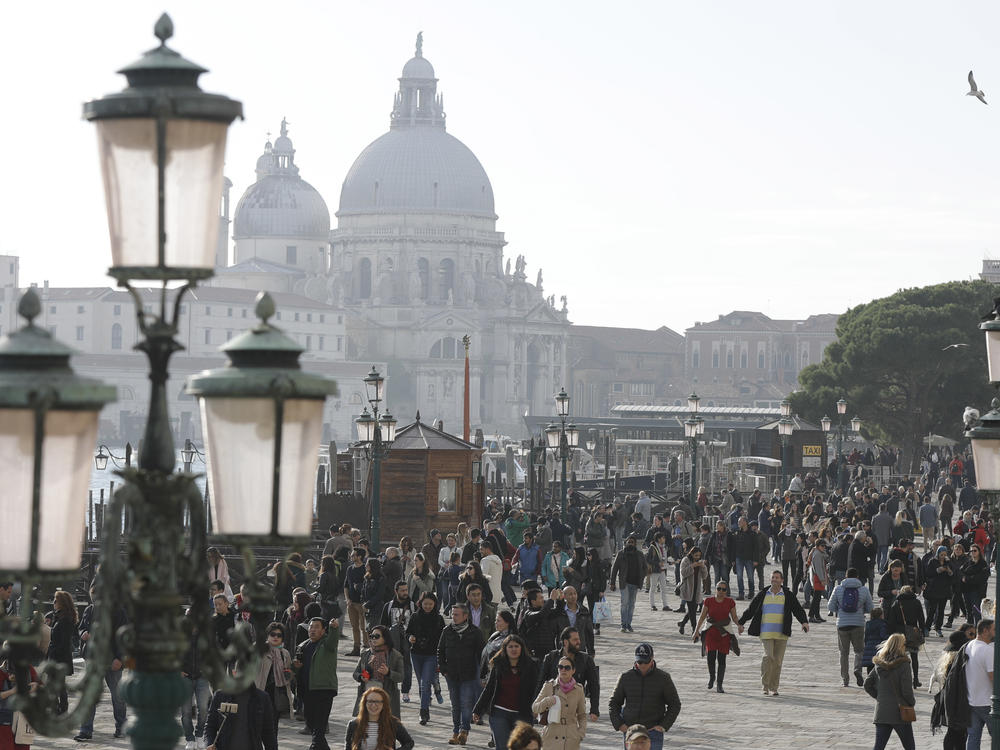 Tourists stroll in downtown Venice in 2016. On many days, the heart of the city is overwhelmed by visitors, who often far outnumber residents.