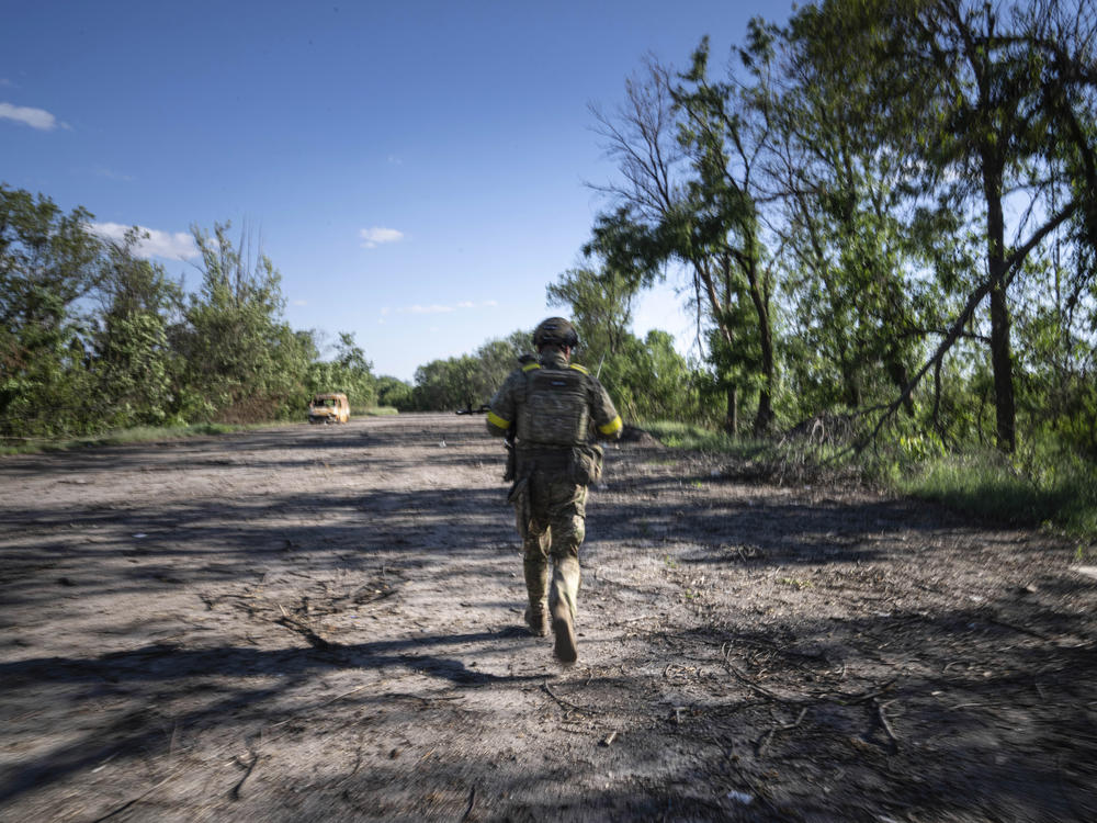 A Ukrainian serviceman changes his position at the frontline near Kharkiv, Ukraine, on Saturday, July 2, 2022.