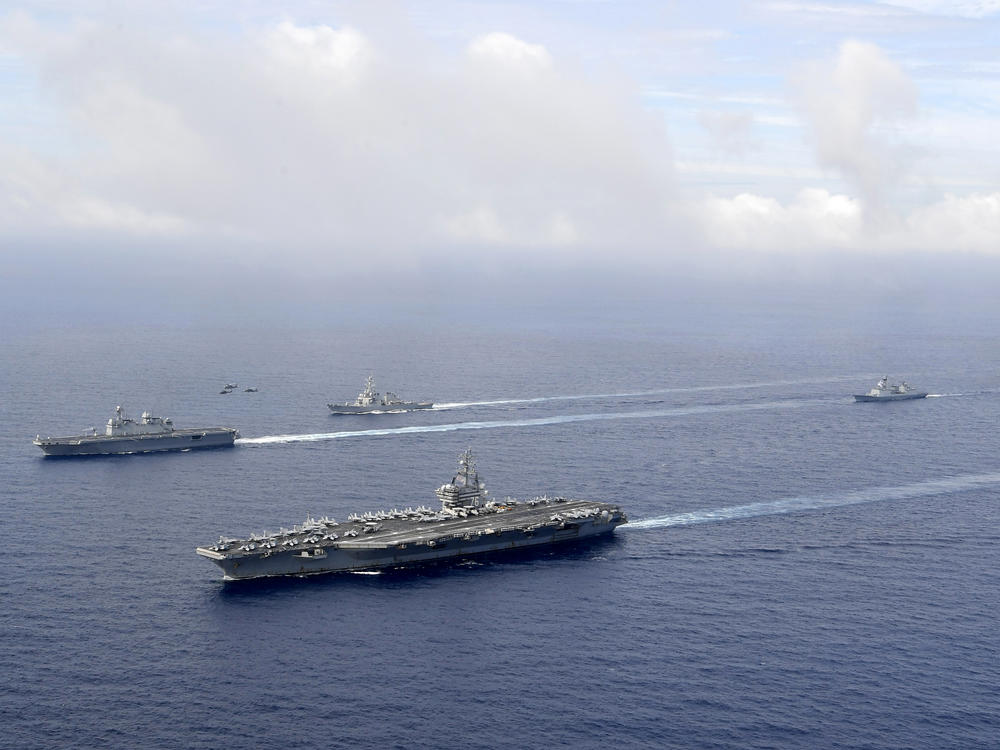 FILE - In this photo provided by South Korea's Defense Ministry, U.S. nuclear-powered aircraft carrier USS Ronald Reagan, second from left, and South Korea's landing platform helicopter (LPH) ship Marado, left, sail during a joint military exercise at an undisclosed location, June 4, 2022.