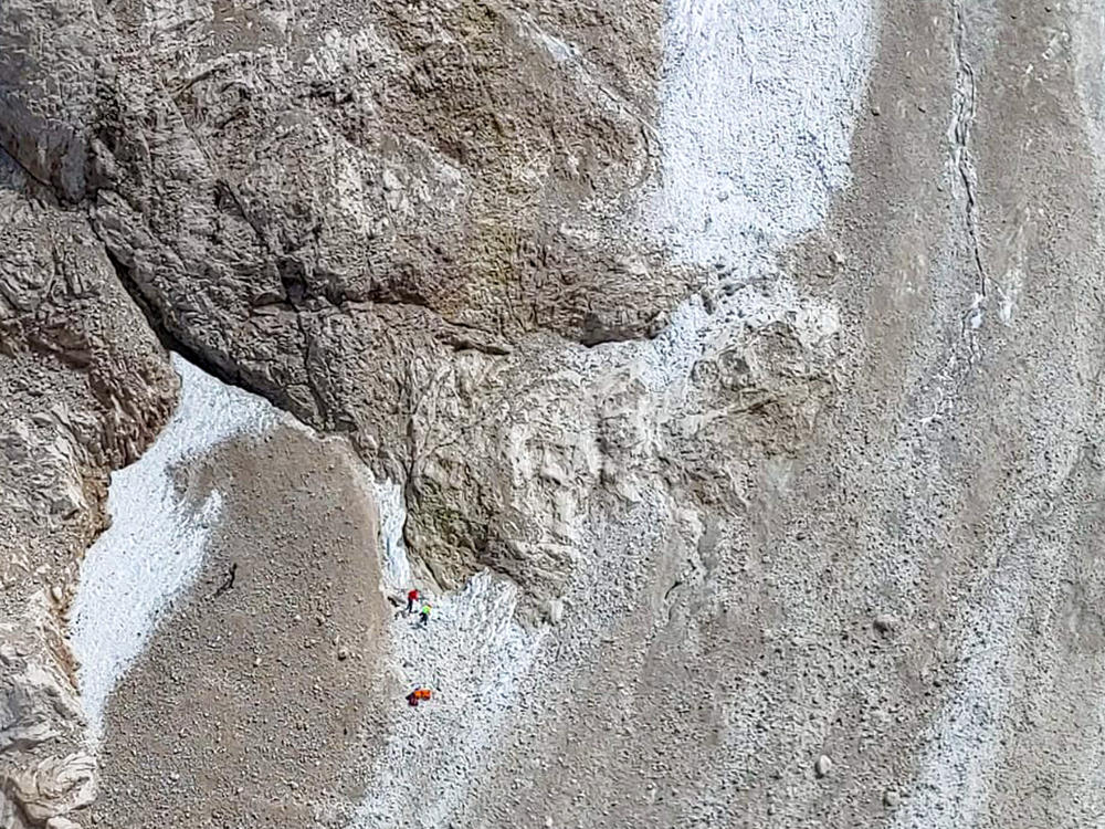 This image released by the Italian National Alpine and Cave Rescue Corps shows the rescue operations on the glacier in Italy's Alps near Trento.