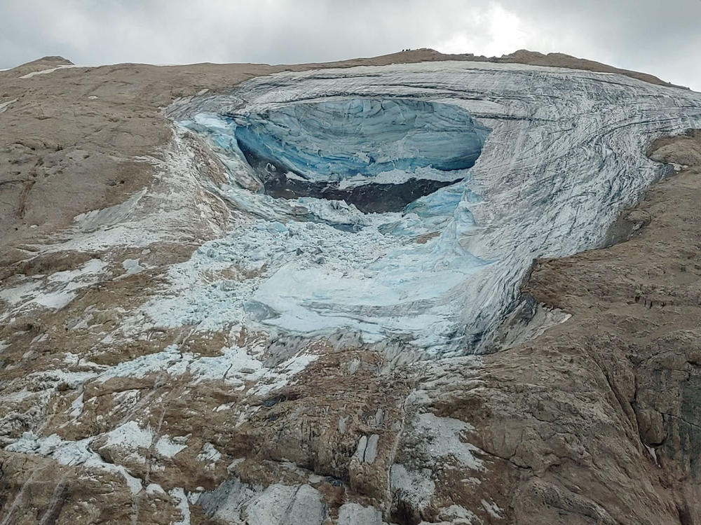 This image released on Sunday by the Italian National Alpine and Cave Rescue Corps shows the glacier in Italy's Alps near Trento, a large chunk of which has broken loose, killing at least six hikers and injuring others.