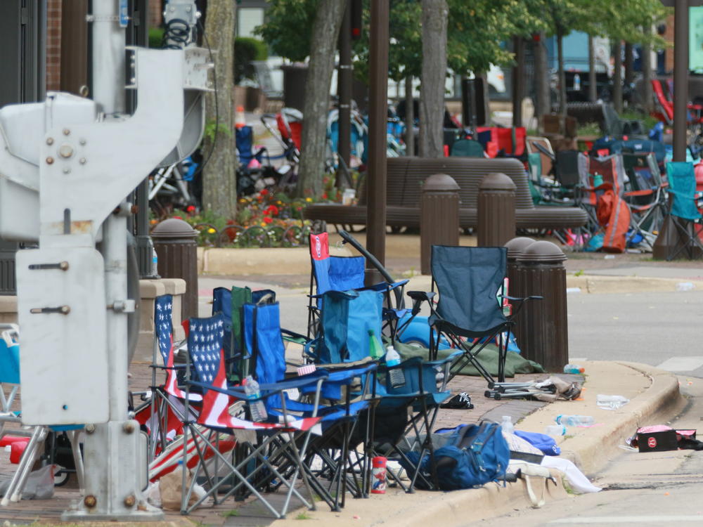 Police detained a suspect in connection with Monday's parade shooting, the aftermath of which is pictured here.