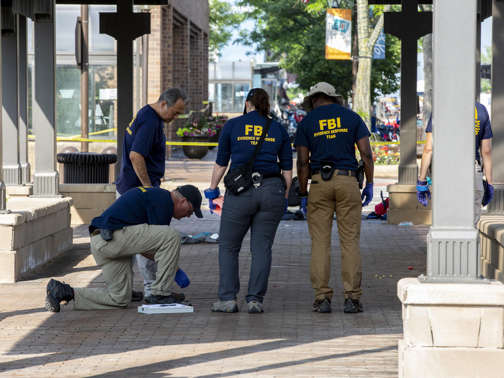 FBI agents work the scene of a shooting at a Fourth of July parade on Tuesday in Highland Park, Ill.