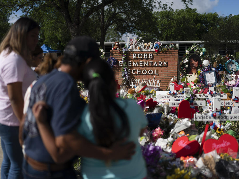 People visit a memorial at Robb Elementary School in Uvalde, Texas, on June 2, 2022, to pay their respects to the victims killed in a school shooting.