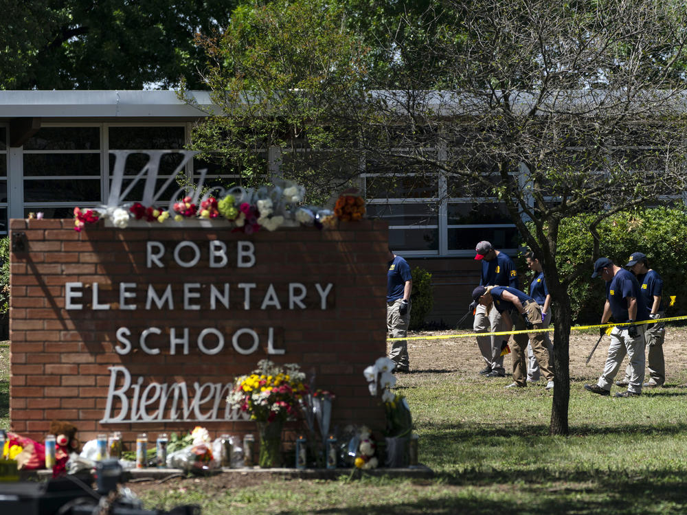 Investigators search for evidences outside Robb Elementary School in Uvalde, Texas on May 25, after an 18-year-old gunman killed 19 students and two teachers.