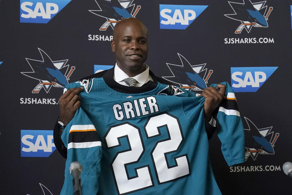 Mike Grier poses for photos as he is introduced as the new general manager of the San Jose Sharks at a news conference in San Jose, Calif., Tuesday, July 5, 2022.