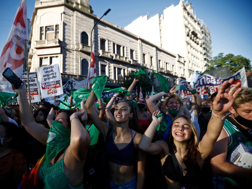 Demonstrators wave green headscarf outside the Argentine Congress in Buenos Aires, in December 2020, where legislators started to debate a bill to legalize abortion.