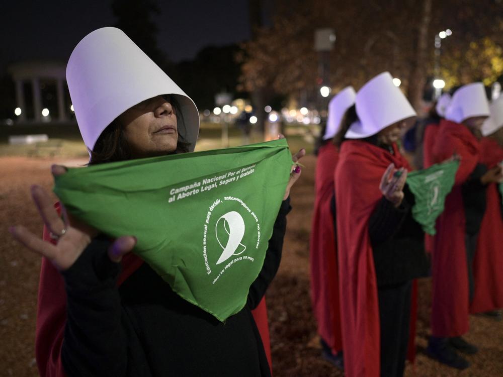 Pro-choice activists disguised as characters from the dystopian novel <em>The Handmaid's Tale</em> display green headscarves in front of the U.S. ambassador's residence in Buenos Aires, on June 30, 2022.