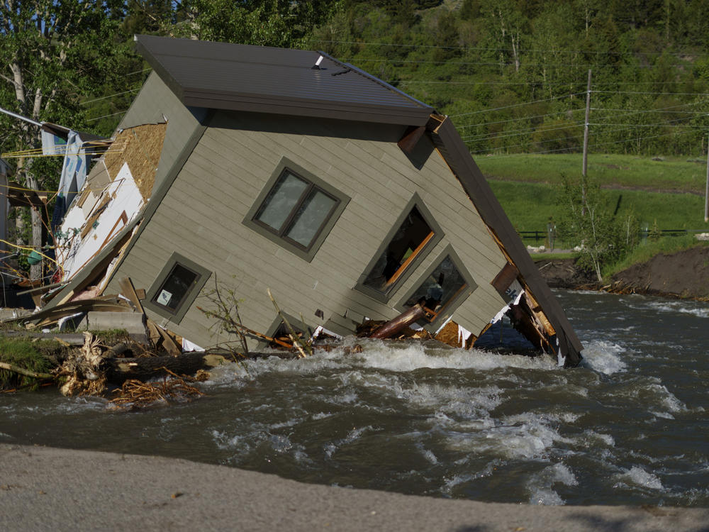 A house sits in Rock Creek after floodwaters washed away a road and a bridge in Red Lodge, Mont., on June 15, 2022.
