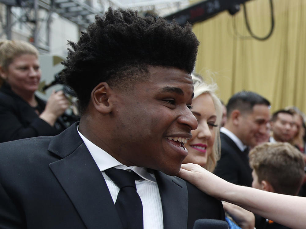 Jerry Harris talks to an actress on the red carpet at the Oscars in Los Angeles in 2020.