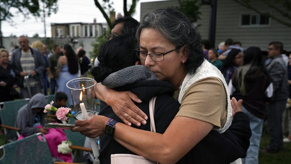 Lucy Barajas hugs Elvia Toledo, the niece of Nicolas Toledo, who was killed during Monday's Highland Park., Ill., Fourth of July parade, during a Wednesday vigil Wednesday in Highwood, Ill.