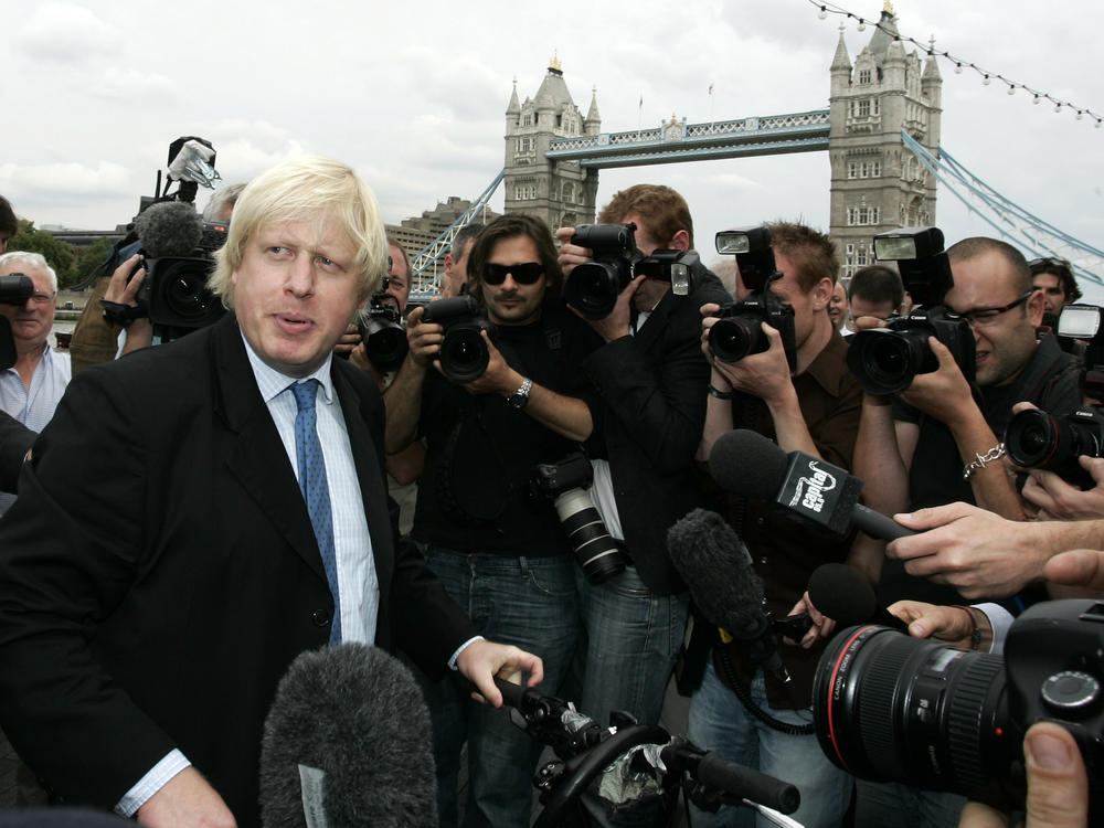 Britain Conservative Party MP, Boris Johnson, left, speaks to the media to launch his campaign as a candidate to be the Mayor of London, outside City Hall in central London, Monday, July 16, 2007.