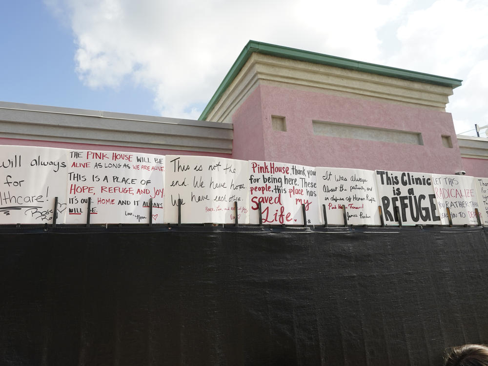Abortion-rights advocates posted supportive signs on the privacy fencing outside the Jackson Women's Health Organization clinic in Jackson, Miss., on July 7, 2022.