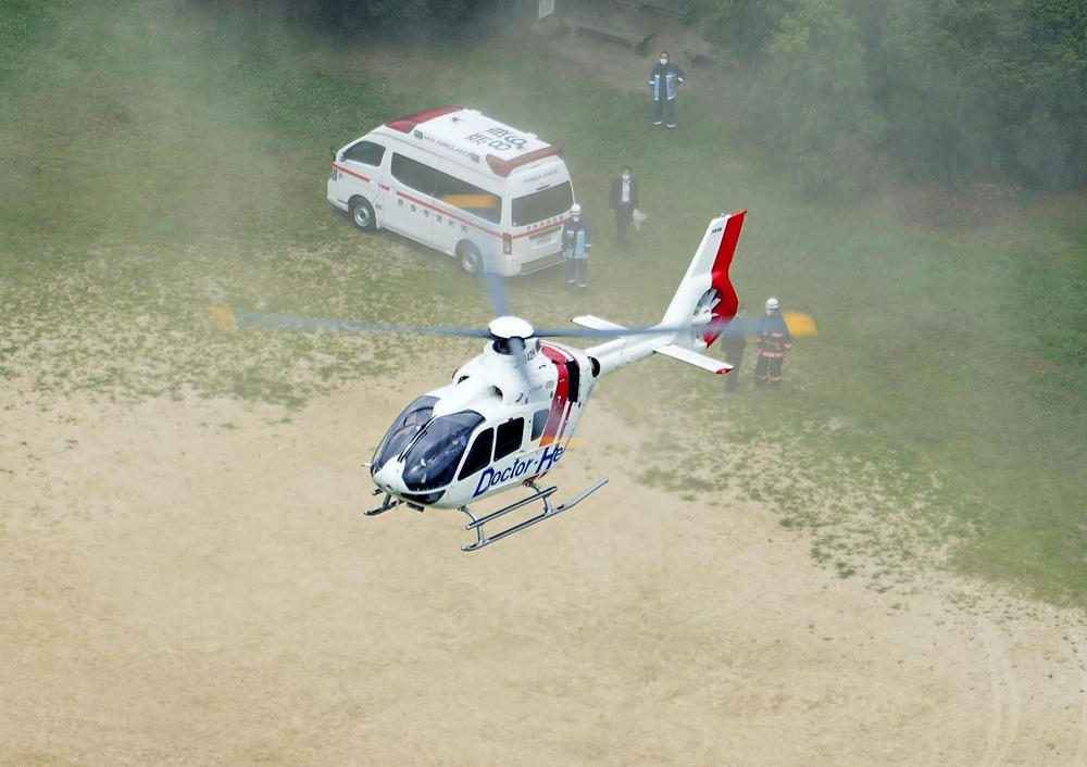 A photo taken from a Kyodo News helicopter in Nara, a city in western Japan, on Friday, shows a helicopter carrying doctors and wounded former Japanese Prime Minister Shinzo Abe, heading to the Nara Medical University Hospital in Kashihara.