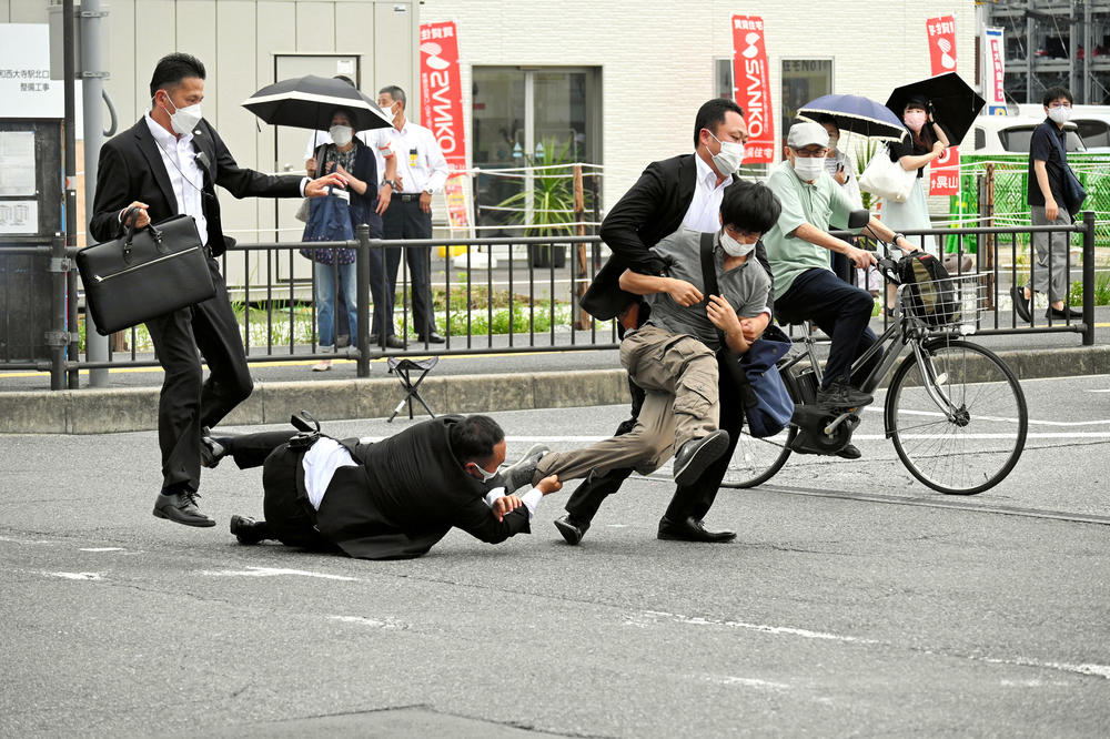 A man believed to have shot former Japanese Prime Minister Shinzo Abe is tackled by police officers in Nara, a city in western Japan, on Friday.