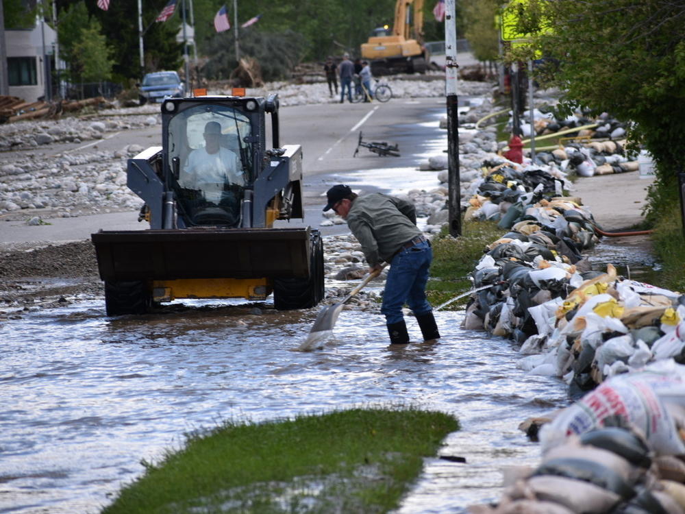Residents of Red Lodge, Mont., clear mud, water and debris from the small city's main street on June 14 after flood waters courses through a residential area with hundreds of homes.