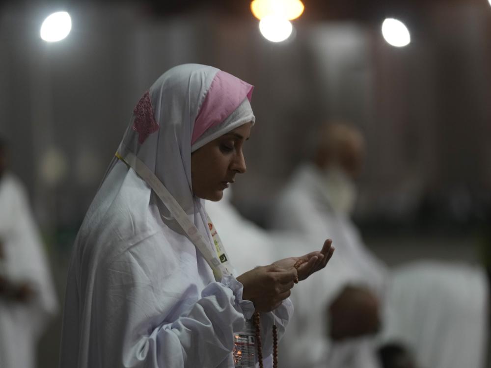 A Muslim pilgrim prays on the Plain of Arafat, during the annual hajj pilgrimage, near the holy city of Mecca, Saudi Arabia, Friday, July 8, 2022.