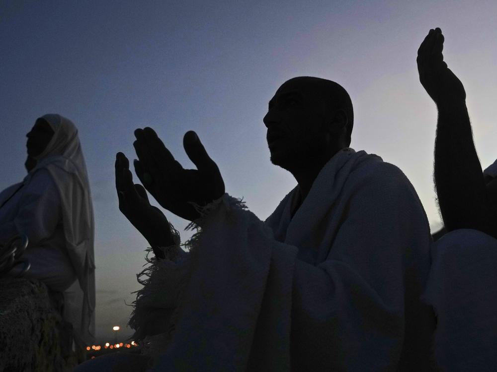 Muslim pilgrims pray on top of the rocky hill known as the Mountain of Mercy, on the Plain of Arafat, during the annual hajj pilgrimage, near the holy city of Mecca, Saudi Arabia, Friday, July 8, 2022.