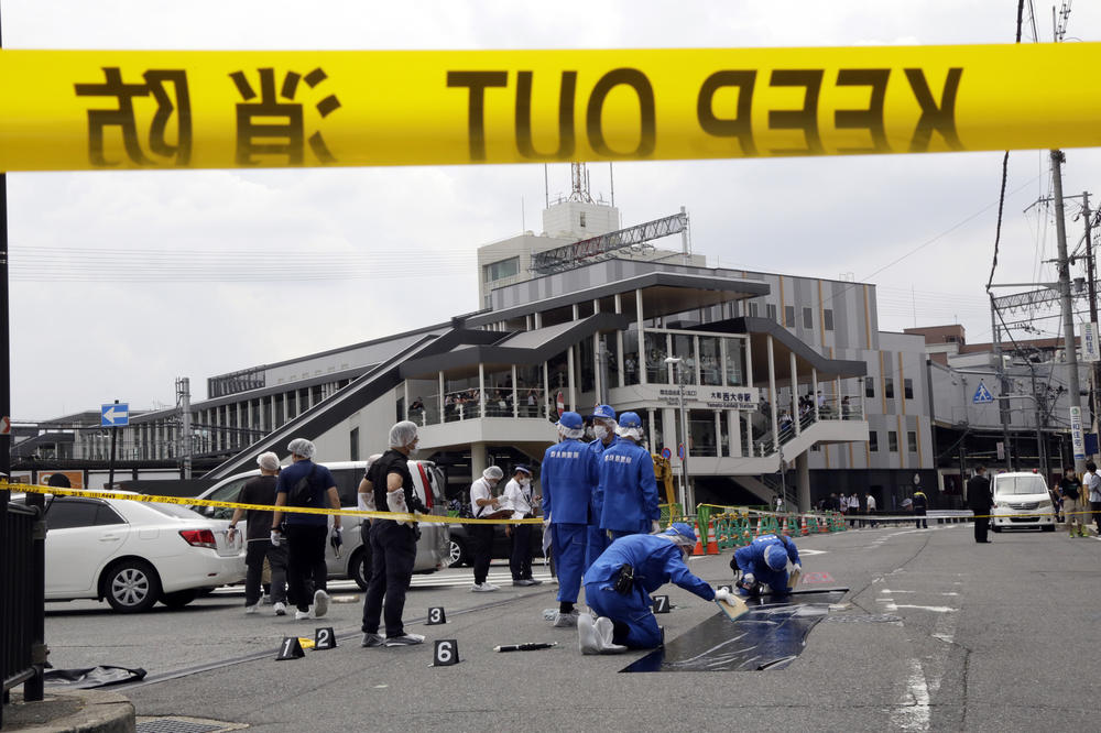 Police officers at the scene where former Japanese Prime Minister Shinzo Abe was shot during a political event in Nara, Japan, on Friday. Abe was unresponsive after being shot and later declared deceased at an area hospital, shocking a nation where gun violence is rare.