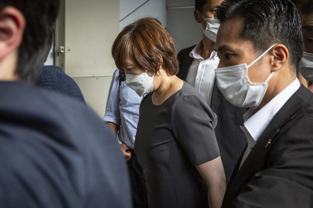 Akie Abe (center), the wife of former Prime Minister Shinzo Abe, arrives at the Yamato-yagi Station on her way to the Nara Medical University Hospital where her husband was transferred after being shot at a political event on Friday in Nara, Japan.