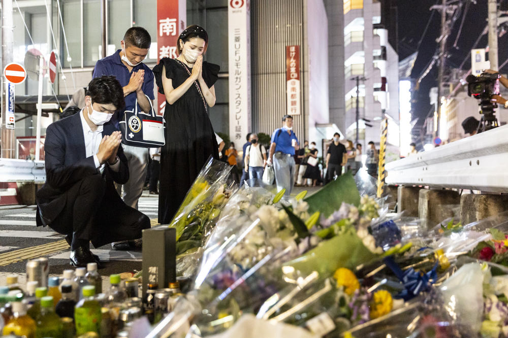 People pray at a site outside of Yamato-Saidaiji Station where former Prime Minister Shinzo Abe was shot earlier Friday during an election campaign speech, in Nara, Japan.