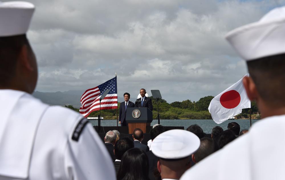 President Barack Obama speaks as Japanese Prime Minister Shinzo Abe listens at Kilo Pier overlooking the USS Arizona Memorial on Dec. 27, 2016, at Pearl Harbor in Honolulu, Hawaii.