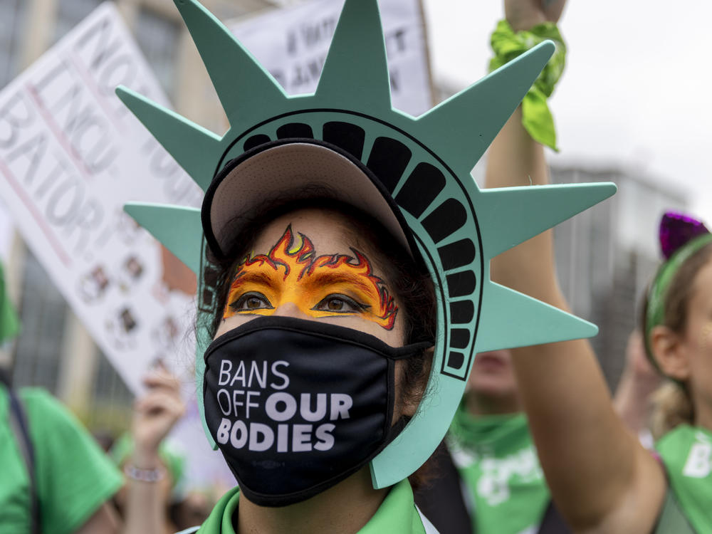 Sonia Glenn from Fairfax, Virginia in a Statue of Liberty costume at the rally in Lafayette Square park before the Women's March in Washington, D.C to protest the Supreme Court's overturning of Roe V. Wade.