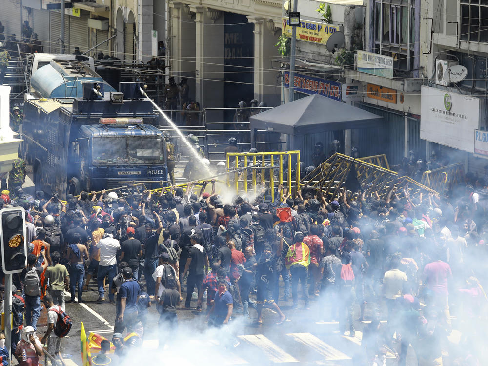 Police use water canon and tear gas to disperse the protesters in Colombo, Sri Lanka, on Saturday.