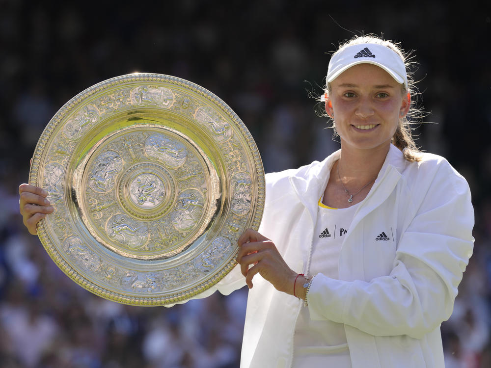 Kazakhstan's Elena Rybakina holds the trophy as she celebrates after beating Tunisia's Ons Jabeur to win the Wimbledon women's single final Saturday.