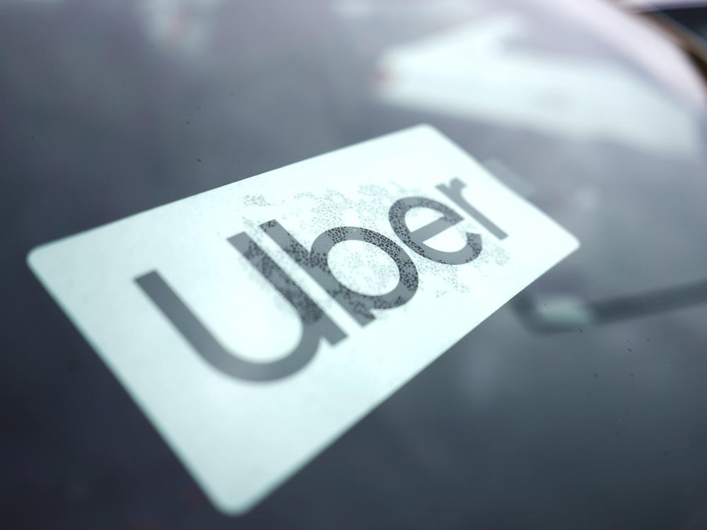 An Uber sign is displayed inside a car in Palatine, Ill., Thursday, Feb. 10, 2022.