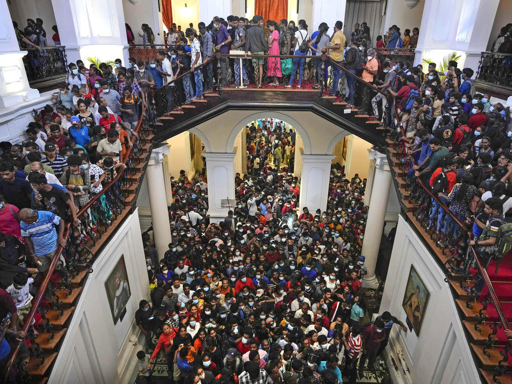 People throng President Gotabaya Rajapaksa's official residence for the second day after it was stormed in Colombo, Sri Lanka, on Monday.