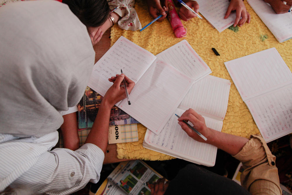 Teenage girls take notes in an English class in a small secret school on the outskirts of Kabul.