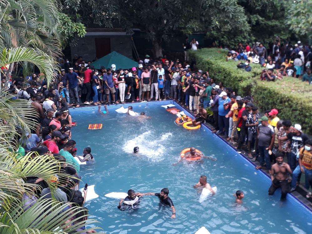 Protesters demanding the resignation of Sri Lanka's President Gotabaya Rajapaksa swim in a pool inside the compound of Sri Lanka's Presidential Palace in Colombo on July 9, 2022.