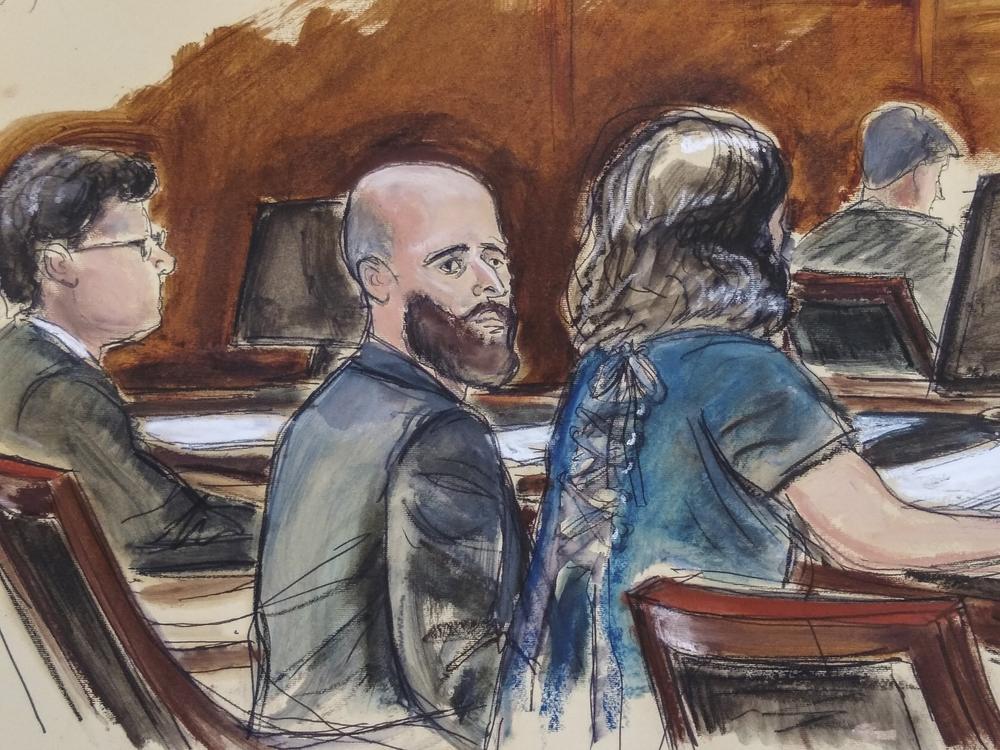 In this courtroom sketch, Joshua Schulte (center) is seated at the defense table flanked by his attorneys on March 4, 2020, in New York.