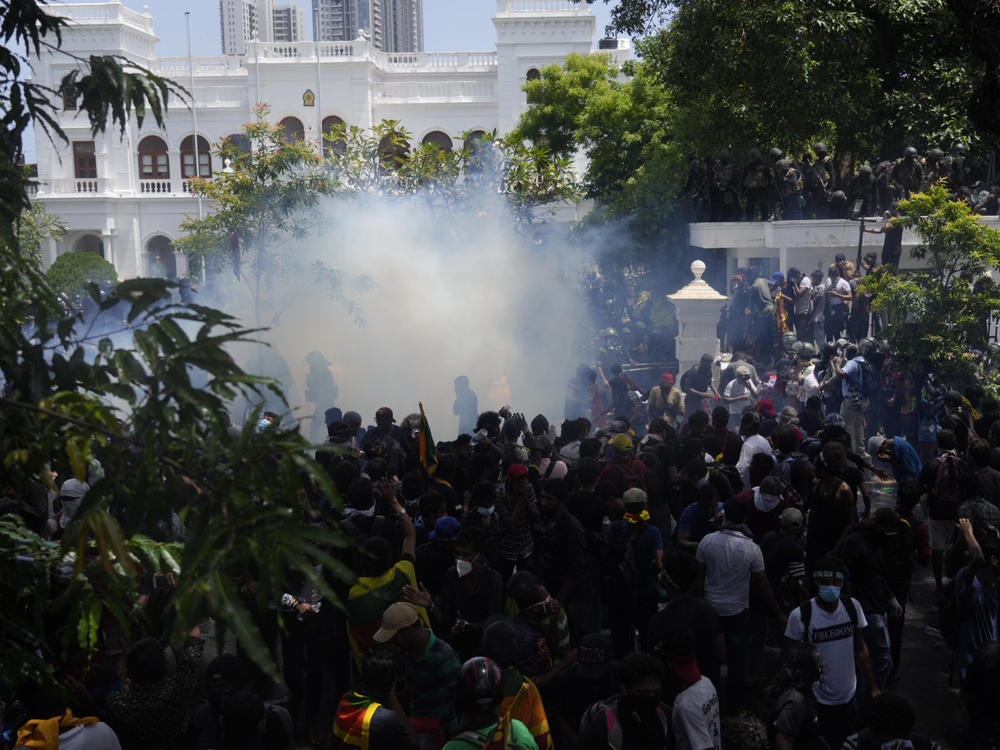 Police use tear gas as Sri Lankan protesters storm prime minister Ranil Wickremesinghe 's office in Colombo, Sri Lanka, Wednesday, July 13, 2022.