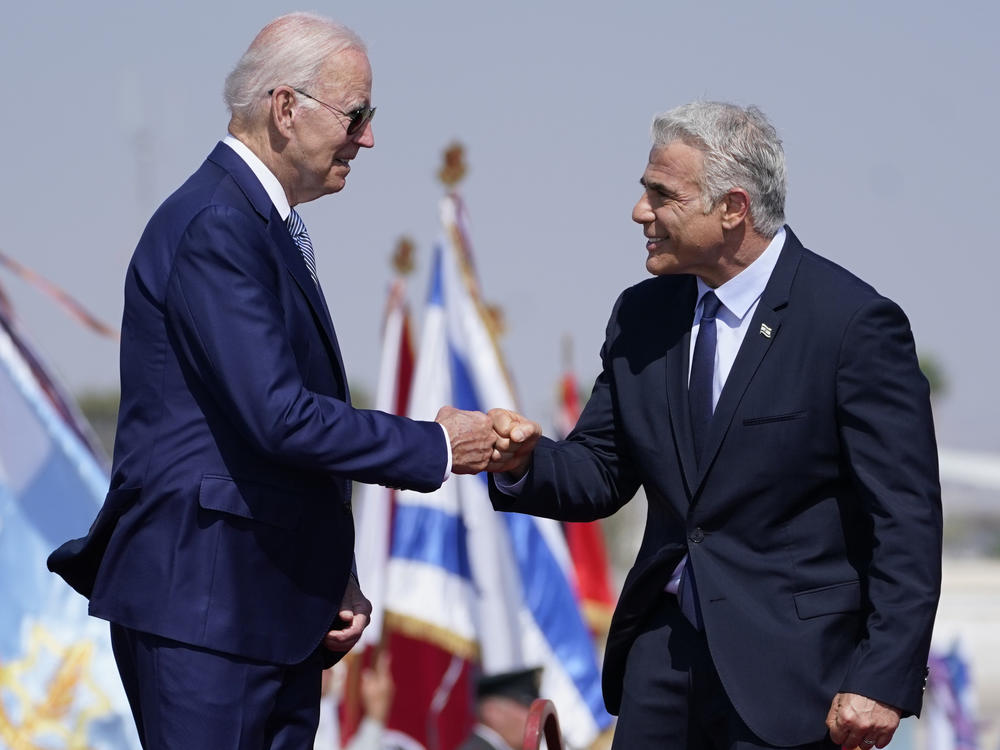 President Biden greeted Israeli Prime Minister Yair Lapid with a fist bump at Ben Gurion Airport in Tel Aviv.