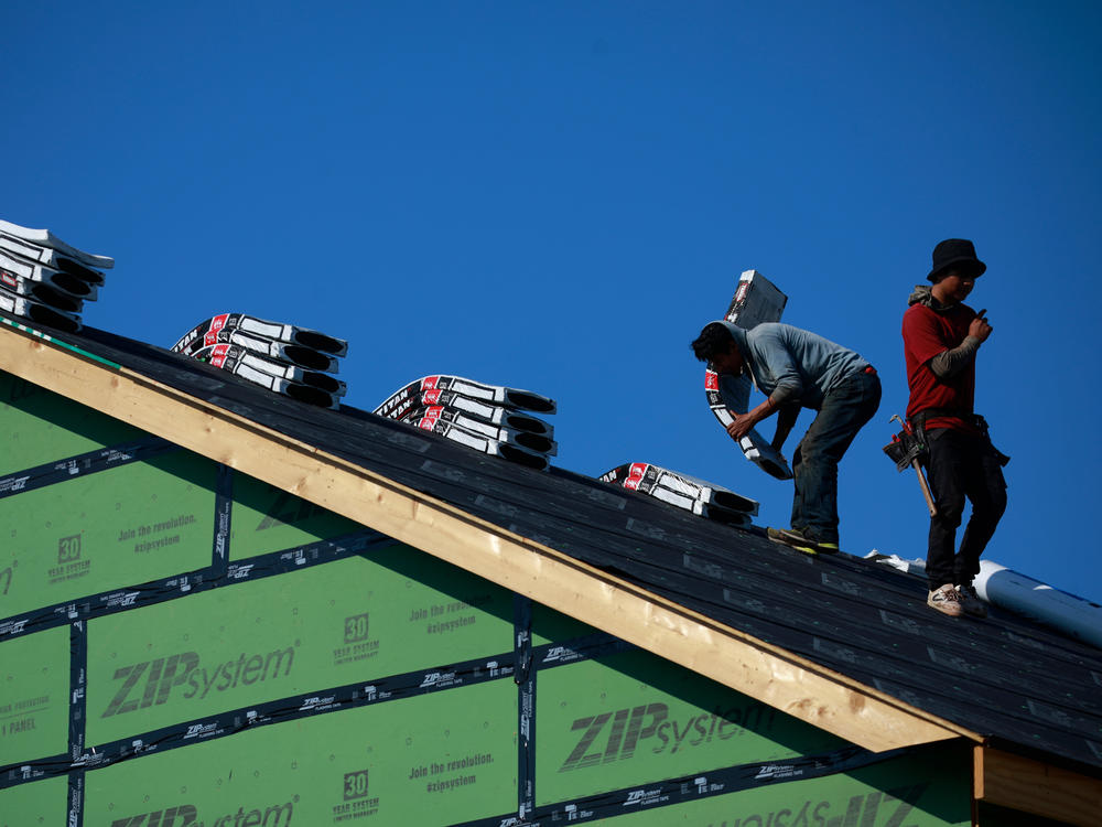 Contractors work on the roof of a house under construction in Louisville, Ky., on July 1. 