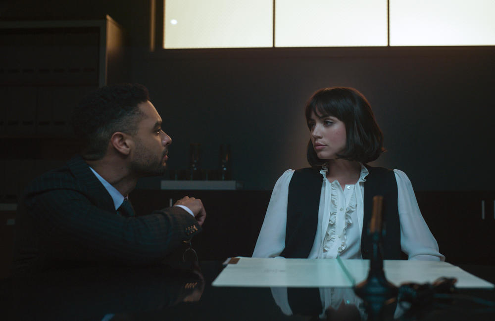 Rege-Jean Page as Carmichael and Ana de Armas as Dani Miranda. Courtesy of Netflix © 2022