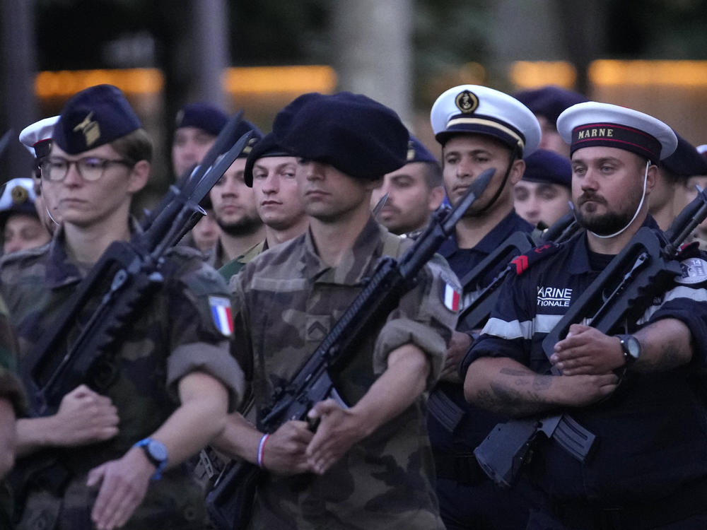 French soldiers march on the Champs Elysees avenue during a rehearsal for the Bastille Day parade in Paris, France, Monday, July 11, 2022.