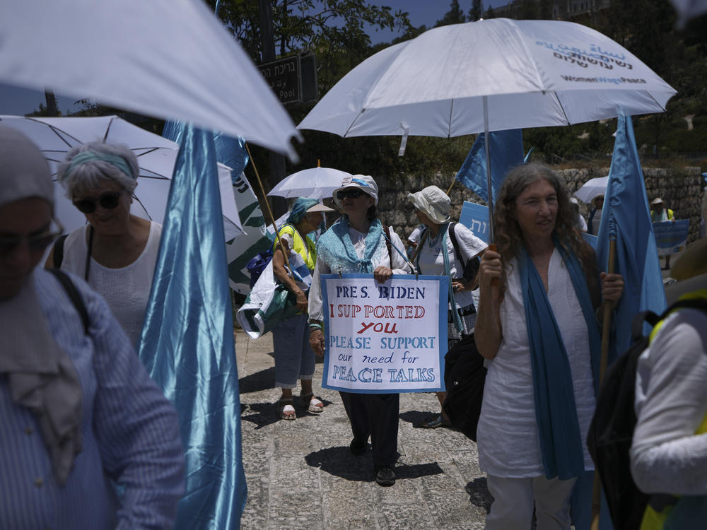 Activists with the Israeli movement Women Wage Peace at a march in Jerusalem, calling on President Biden to put peace between Israel and the Palestinians on the agenda during his Middle East trip.