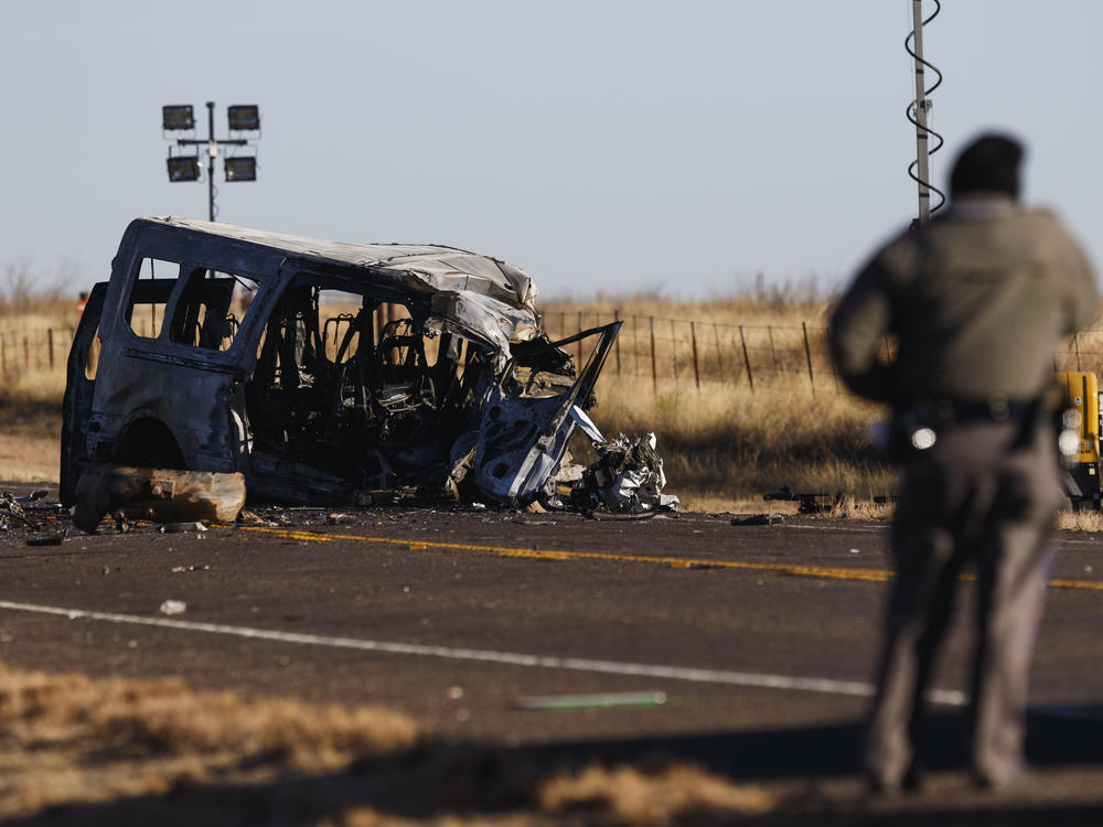 Texas Department of Public Safety Troopers look over the scene of a fatal collision in March in Andrews County, Texas. A pickup truck crossed the center line of a two-lane road and crashed into a van carrying members of the University of the Southwest men's and women's golf teams.
