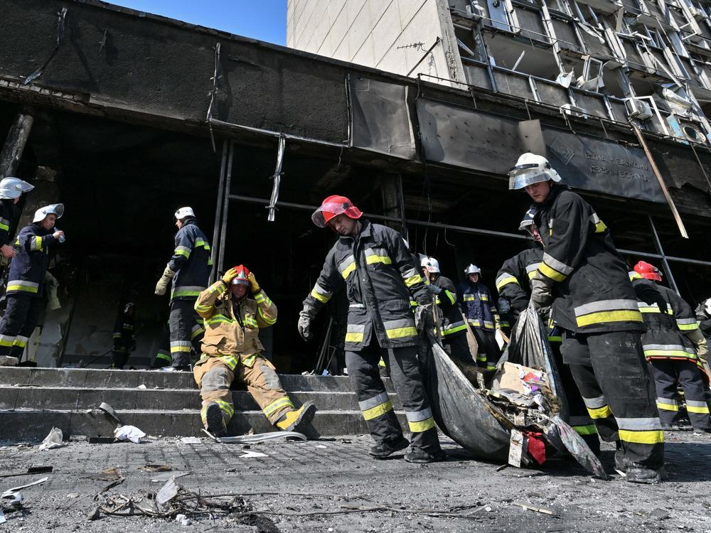 Firefighters remove rubble following a Russian airstrike in the central city of Vinnytsia on Thursday that Ukrainian officials said killed more than 20 people and injured dozens more.